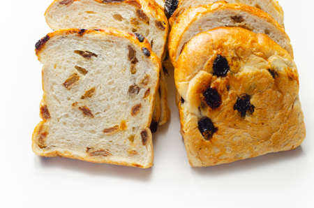 Fruit loaf with sultanas and orange flavored pieces on the white background, traditional fruit breadの写真素材
