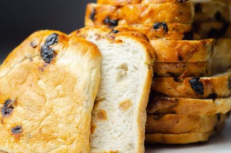 Fruit loaf with sultanas and orange flavored pieces on the white background, traditional fruit breadの写真素材