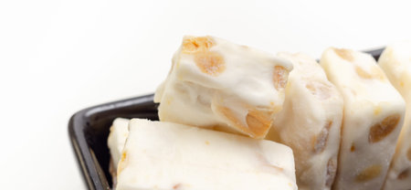 Traditional confections made with sugar or honey, roasted nuts and whipped egg whites, soft nougat barsの写真素材
