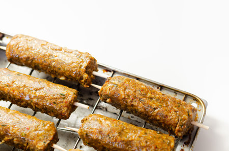 Minced and shaped lamb kebabs with chilli and coriander prepared for grill, traditional turkish...