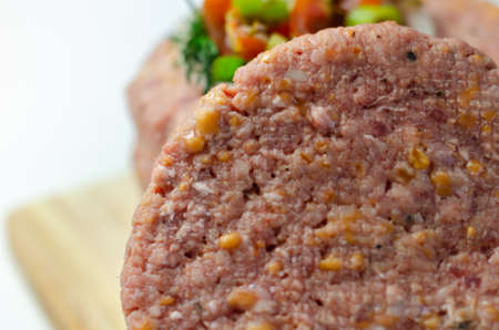 Raw beef burgers blended with caramelised red onion and tangy red Leicester cheese prepared for grilling, delicious foodの写真素材