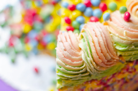 Madeira sponge coated with yellow colour frosting, layered with plum and raspberry jam, filled and...