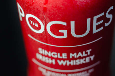 LONDON, UNITED KINGDOM - OCTOBER 30, 2021 Red bottle of The Pogues, single malt Irish matured in bourbon oak casks, made at the Irish distillery on West Corkのeditorial素材