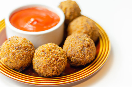 Southern fried chicken bites with tomato dip, chopped and shaped chicken breast with coated in...