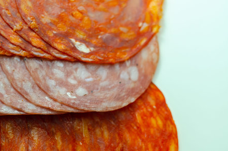 Set of three sliced Spanish sausages, two kind of chorizo and salchichon, cured and dried pork...
