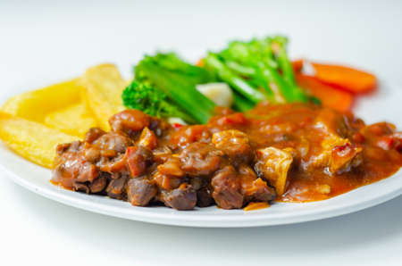 Pulled pork in barbecue style sauce with barbecues style beans with spiced chips and fresh vegetables , american mealの写真素材