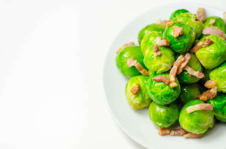 Tasty brussels sprouts with smoked bacon lardons and salted butter, delicious foodの写真素材