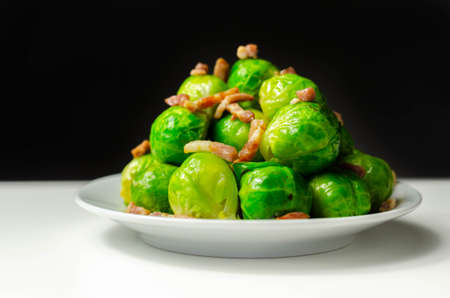 Tasty brussels sprouts with smoked bacon lardons and salted butter, delicious foodの写真素材