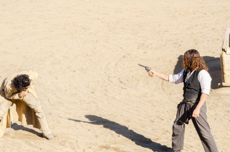 ALMERIA, SPAIN - 17 DECEMBER 2022 Dressed in distinctive Wild West costumes, actors in a Western town put on a bank robbery showのeditorial素材