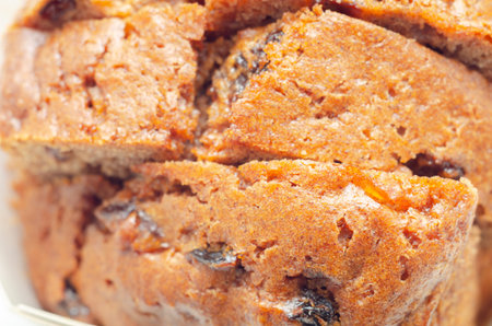 Freshly made spiced fruit  loaf cake  on the white  background, traditional British cake