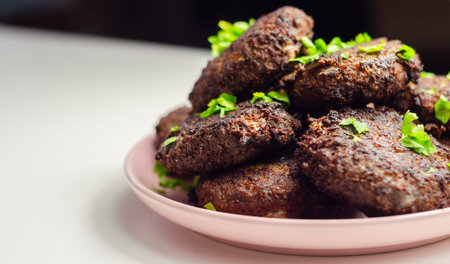 Fried minced cutlets served in a pile on a plate, typical eastern european homemade food, tasty dishの写真素材