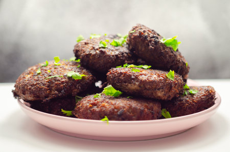 Fried minced cutlets served in a pile on a plate, typical eastern european homemade food, tasty dishの写真素材