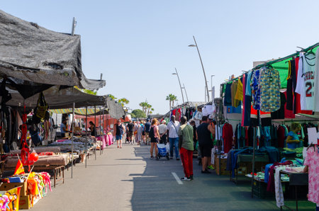 ROQUETAS DE MAR, SPAIN -  05 OCTOBER 2023 Local market with a large number of stalls where you can buy bags, clothes, shoes and accessories, jewelry, decorations, household items, handicrafts, flowers and plants, etc.のeditorial素材