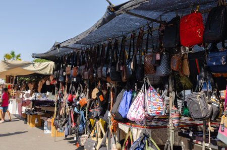 ROQUETAS DE MAR, SPAIN -  05 OCTOBER 2023 Local market with a large number of stalls where you can buy bags, clothes, shoes and accessories, jewelry, decorations, household items, handicrafts, flowers and plants, etc.のeditorial素材