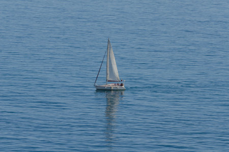 yacht sailing the sea, clear sky and blue water, recreational sport, active rest