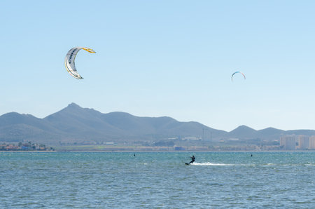 LA MANGA, SPAIN - 27 FEBRUARY 2019 People practising the water sport of kitesurfing on a shallow lagoon located in La Manga, Spainのeditorial素材