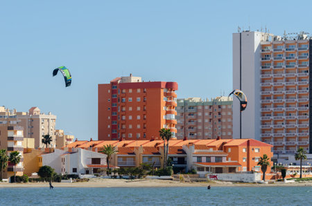 LA MANGA, SPAIN - 27 FEBRUARY 2019 People practising the water sport of kitesurfing on a shallow lagoon located in La Manga, Spainのeditorial素材