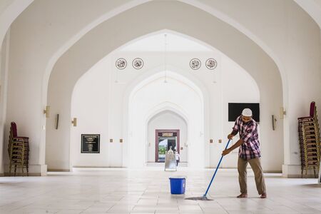 Shah Alam - 25 November 2017 : Man cleaning floor at Masjid Diraja Tengku Ampuan Jemaah, Bukit Jelutong, Shah Alam, Selangor, Malaysiaのeditorial素材