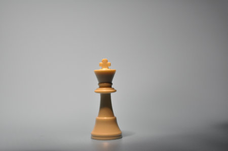 An isolated white king chess with white backgroundの写真素材