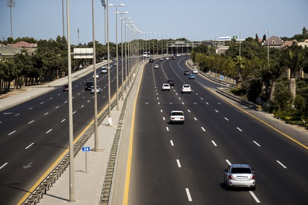 Asphalted flat central straight road in the early morningの写真素材
