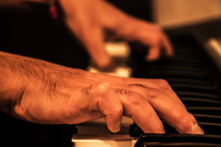 Hands playing the piano