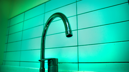 Faucet sink at kitchen - vintage light tone filterの写真素材