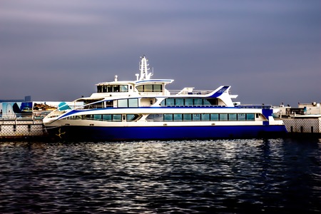 Luxurious white and blue yacht stands on the surface of the Caspian Sea waterの写真素材