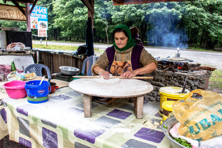 The woman is preparing the Azerbaijani bread in the eatery near the road leading from Baku in Gebel 03.06.2018. yearのeditorial素材