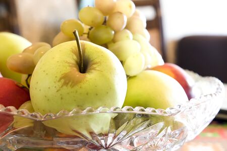Fresh fruits in a vase on the kitchen tableの写真素材