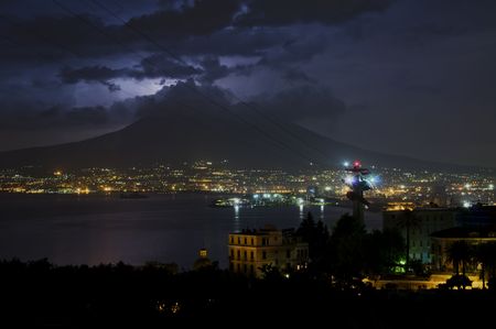 Vesuvius at night with clouds and lightningの写真素材