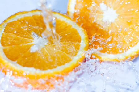 Fresh cut orange under the water streamの写真素材