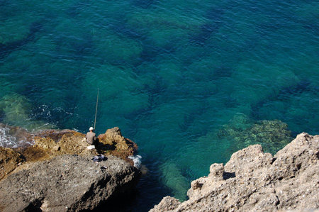 Fisherman on a rock
