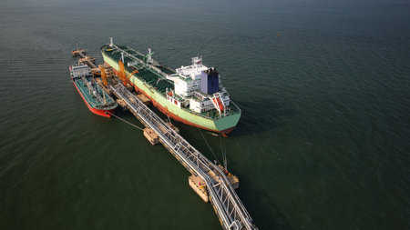Carrier ships beside a port bridge