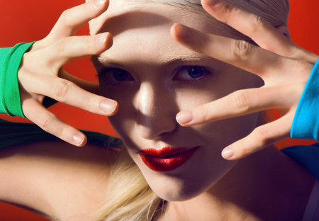 fantastic lady whit red lips on red background magik look at camera