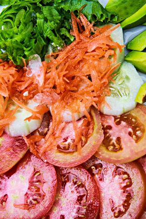 salad mix  from tomatoes of onions laid out on  plateの写真素材