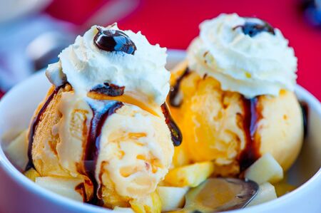 Delicious Ice Cream in white bowl. Colourful close-upの写真素材