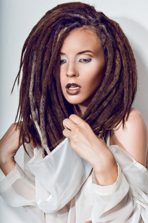 Beautiful girl with dreadlocks in white suitの写真素材
