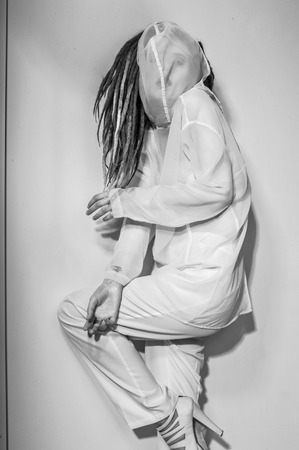 Beautiful girl with dreadlocks in white suitの写真素材