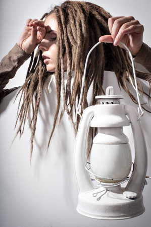 Beautiful girl with dreadlocks in white suitの写真素材
