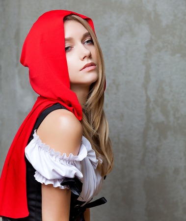Beautiful fashion woman in Little Red Riding Hood suitの写真素材