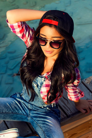 Girl with beautiful black hair in sunglassesの写真素材
