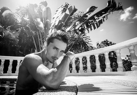 Man posing in swimming poolの写真素材