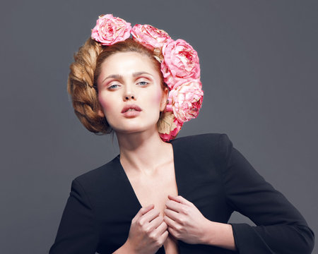 Close up portrait of art color woman face in black jacket with  flower wreath on headの写真素材