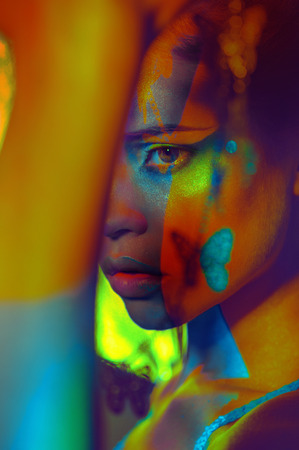 Close up portrait of woman color face art makeup.Bright cosmeticsの写真素材