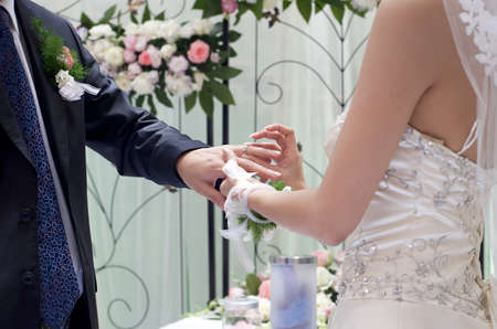 a young couple exchange ring on their wedding dayの写真素材