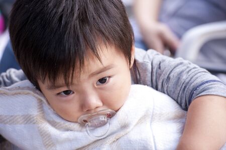 sleepy baby with pacifierの写真素材