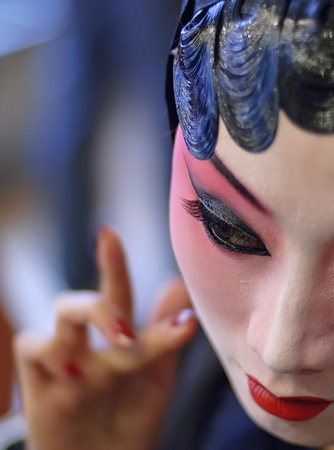 CHENGDU - Dec 15: a chinese opera actress is painting her face at backstage at JingJiang theater on Dec 15,2007 in Chengdu; China.のeditorial素材