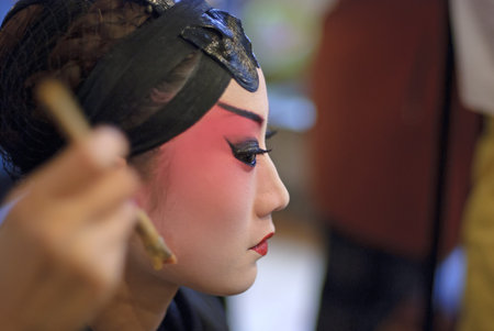 CHENGDU - Dec 15: a chinese opera actress is painting her face at backstage at JingJiang theater on Dec 15,2007 in Chengdu; China.のeditorial素材