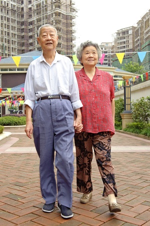 an intimate senior couple are walkingの写真素材