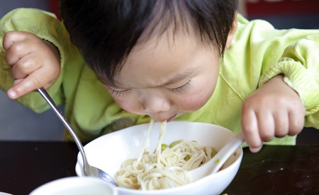 a cute baby is eatingの写真素材